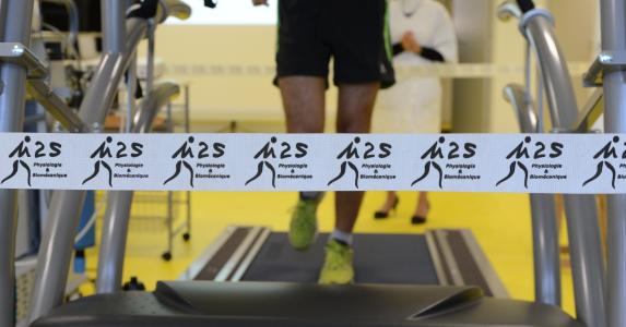 A man on a treadmill with M2S logo next to him