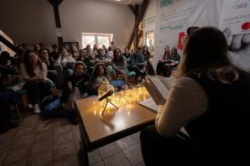 Image of students sitting together in a circle reading and listening