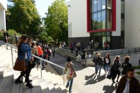 Front of Building D with students walking